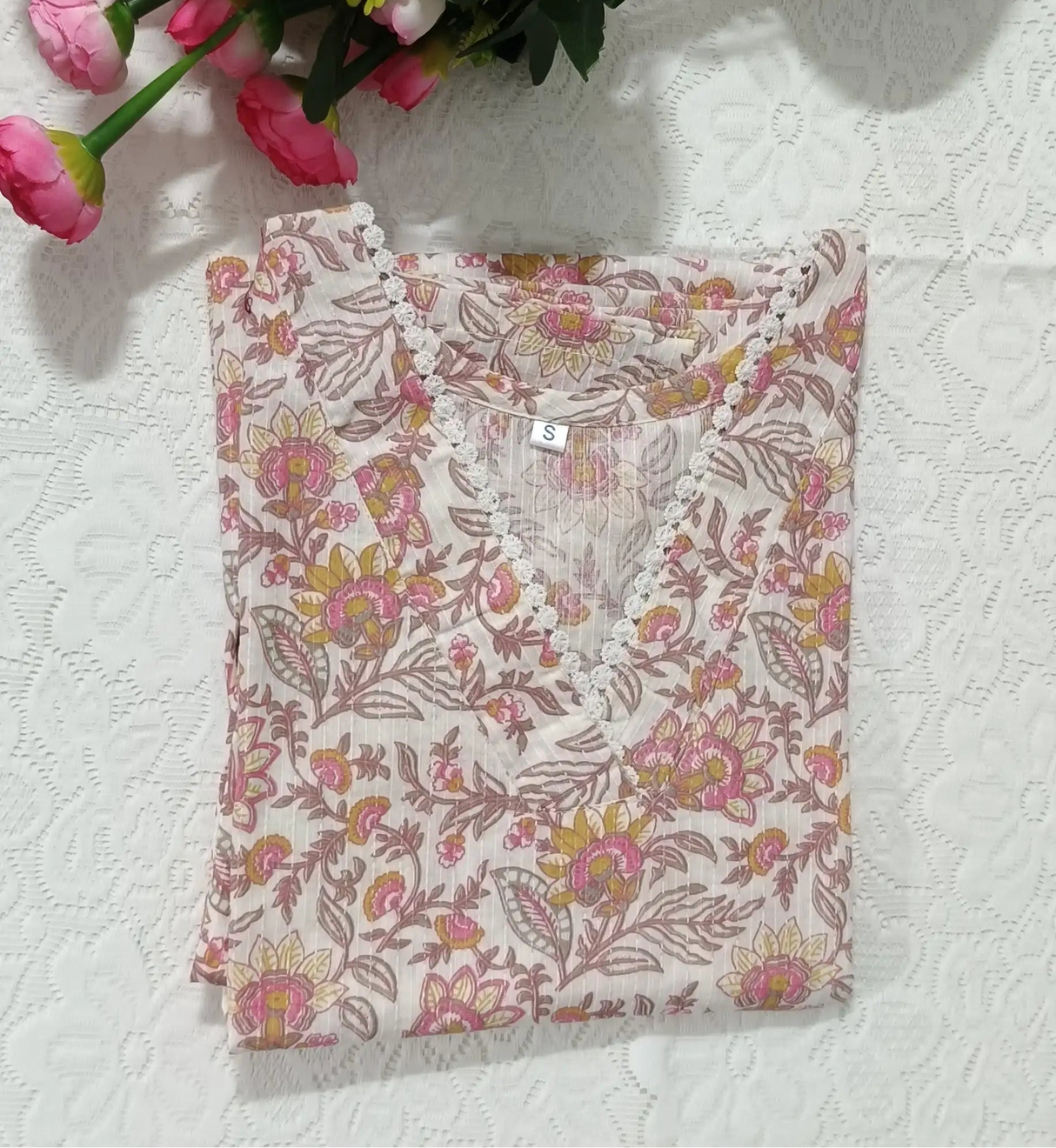 Floral fabric with pink flowers on a white textured background