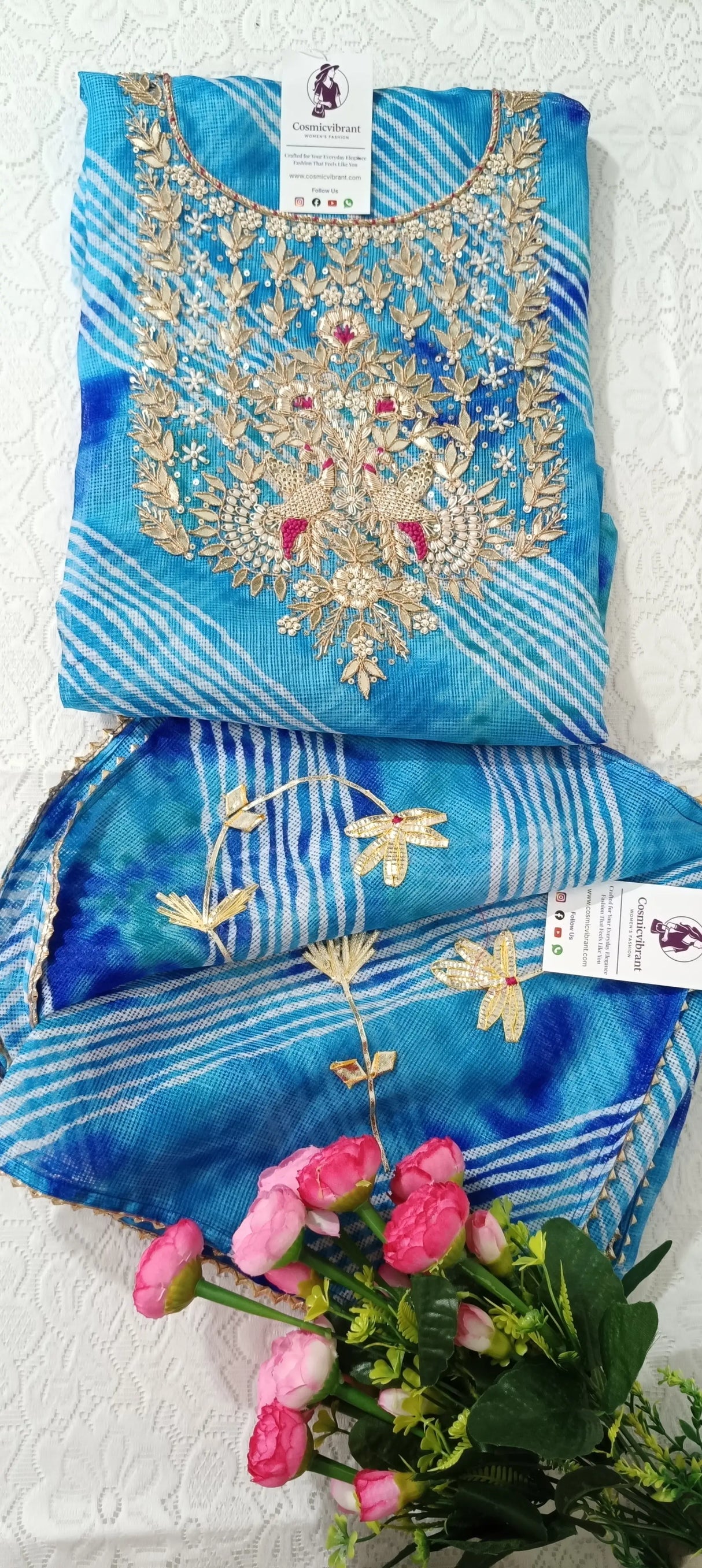 Blue embroidered fabric with gold detailing on a white background