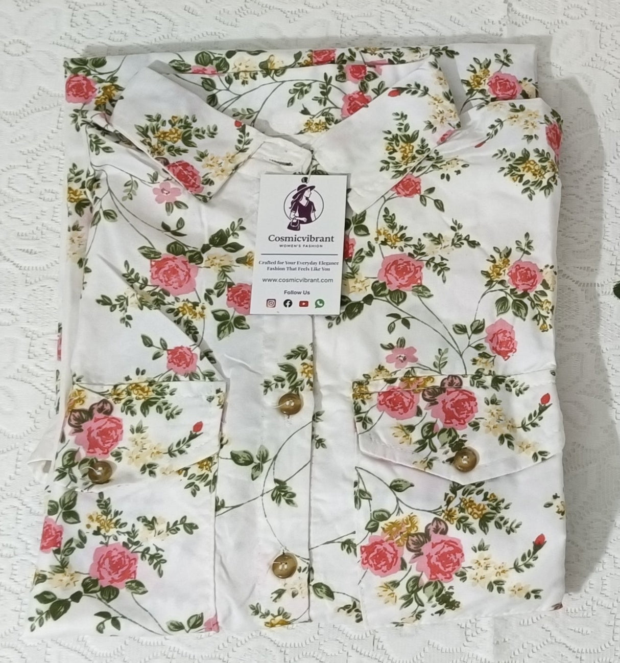 Floral-patterned fabric with a tag on a textured white background