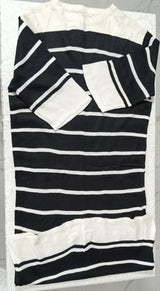 Black and white striped fabric with ruffled edges on a marble surface