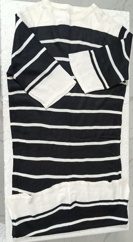 Black and white striped fabric with ruffled edges on a marble surface