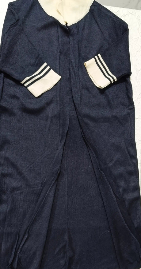 Navy blue garment with white accents on a light gray background