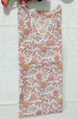 Floral-patterned fabric on a textured surface with pink flowers and green leaves.