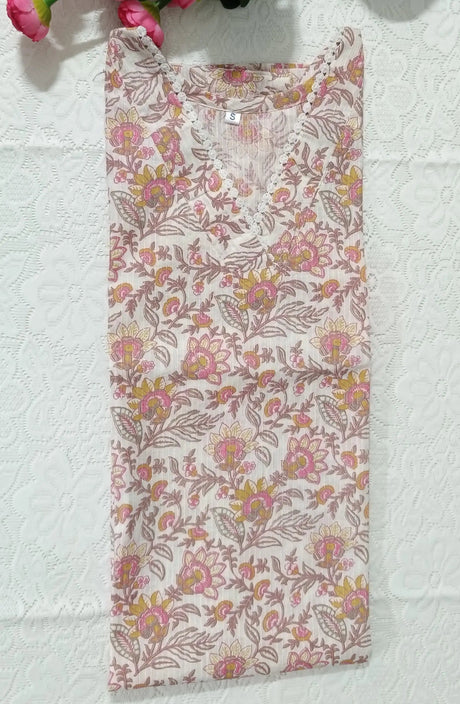 Floral-patterned fabric on a textured surface with pink flowers and green leaves.