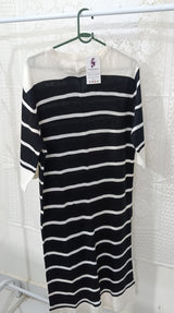 Black and white striped dress on a hanger with a white background