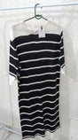 Black and white striped dress on a hanger with a white background