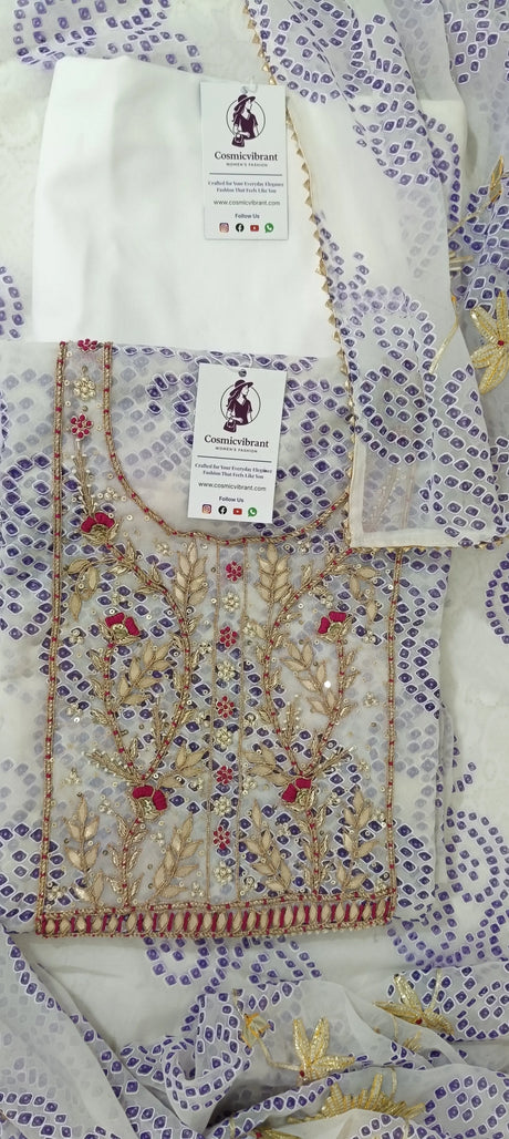 Textile with floral patterns and embroidery, featuring a brand tag.