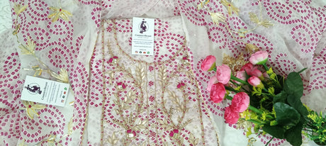 Floral fabric with pink flowers and green leaves on a patterned background