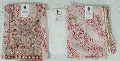 Two patterned scarves with tags on a white surface
