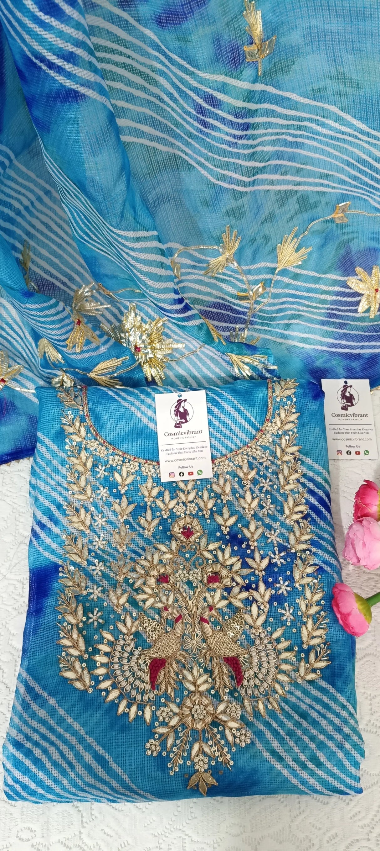 Blue embroidered fabric with gold detailing on a white background