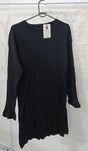 Black ribbed sweater on a hanger against a textured white background